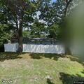 Woman experiencing back pain near Corbin Avenue in Tudor