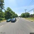 Car crash sends gray sedan into woods