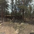Unattended campfire smoldering behind residence