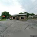 Vehicle crash with car tire on fire near pizza shop
