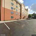 Man burning item in hotel parking lot