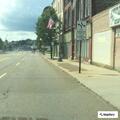 Female undergoing detox lies on sidewalk at bus stop