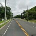 Red tow truck blocking traffic on Montauk Highway