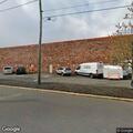Caller reports shirtless man chasing him in lot