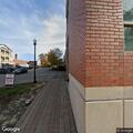 Young male leaves parking deck in gray Tesla