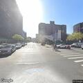 Man panhandling and holding gate open at station