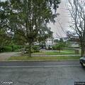 Person on bicycle hiding in bushes on property
