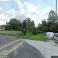 Man screaming and holding brick behind Wolcott home