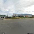 Female in mid-20s with back pain at Amazon building