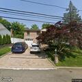 Person reporting abdominal pain at residence in Roslyn Harbor