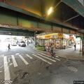 Female with feet dangling over subway platform edge