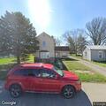 Smoke alarm sounding at vacant house on porch