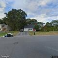 Stopped gold sedan reported as road hazard