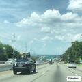 Car hits deer and begins smoking on highway ramp