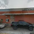 Vehicles blocking traffic near restaurant