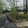 Two men arguing in driveway near Cozy Lane