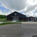Person standing close to roadway in dark clothing