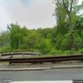 Male appears agitated walking along road near park