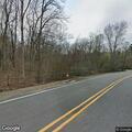 Tree hanging on power lines over roadway in West Milford