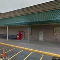 Man offering car bodywork in supermarket lot
