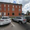 Car hits restaurant building; driver reports knee pain