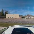 Older man sits in vehicle behind store, concern raised
