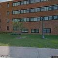 People smoking on lower roof of Lake Olson Hall
