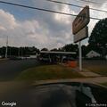 Person walking in traffic near restaurant