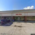 Person experiencing chest pain on bench at restaurant