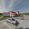 Person sleeping by propane tank at Circle K