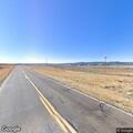 Car drives past road flaggers near Little Laramie