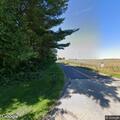 Car leaves roadway and stops in nearby field