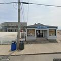 Female fall victim with uncontrolled leg bleeding at beach arcade