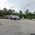 Male slumped over wheel at gas station