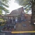 Man taking a nap on bench in Stonington Village