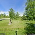 Person driving golf cart through park property