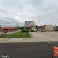 Red pickup blocks driveway on Broadway Avenue