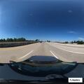 Person sitting on highway shoulder in North Randall
