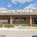 Officer checks vehicle in front of Berkot's store
