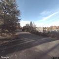 People taking photos of car outside Walden home