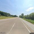 Male lying in the middle of the road in Le Claire