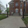 Man helped from wheelchair into vehicle at courthouse