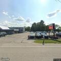 Police standby at auto dealer for item pickup