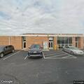 Suspicious person with laptop outside Northwood school