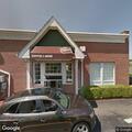 Car hits light pole in parking lot, woman injured