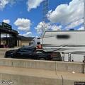 Person digging in donation bin in parking lot
