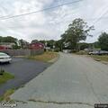 Loose dog with leash running in roadway