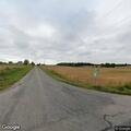 Officer conducting crash follow-up at rural home