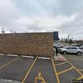 Person with abdominal pain in parking lot of cafe