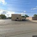 Person asleep at wheel in pickup truck in parking lot